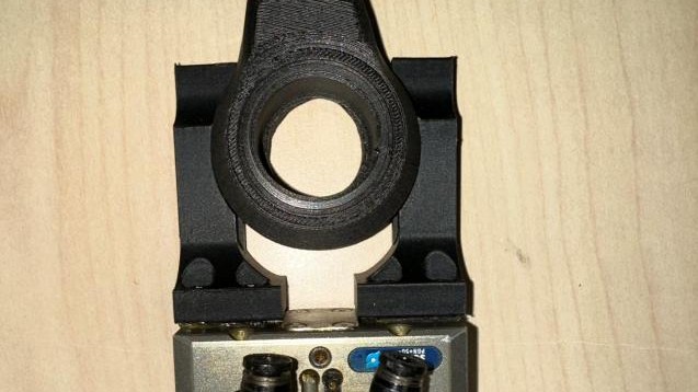 Custom FANUC robot end-effector for part handling.